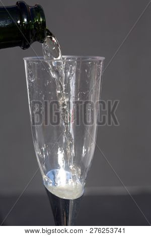 Champagne. Pouring Champagne into a glass. Glass of Champagne.