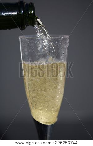 Champagne. Pouring Champagne into a glass. Glass of Champagne.