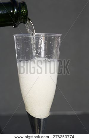 Champagne. Pouring Champagne into a glass. Glass of Champagne.