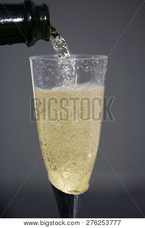 Champagne. Pouring Champagne into a glass. Glass of Champagne.