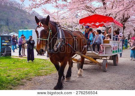 Iwate , Japan - April 22 2018: A Horse Carriage Carry A Group Of Tourists Rolls Through The Tunnel O