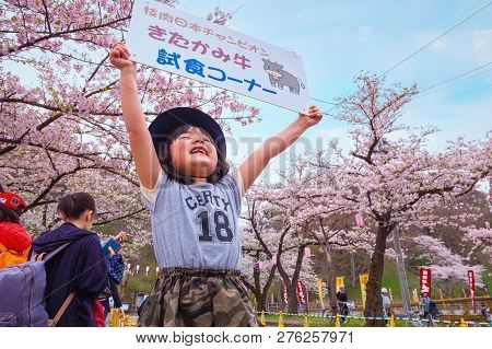 Iwate , Japan - April 22 2018: Unidentified Young Japanese Girl Holds Sign Selling The Kitakami Beef