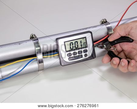 Hand Cutting Wire On Pipe Bomb On White Background