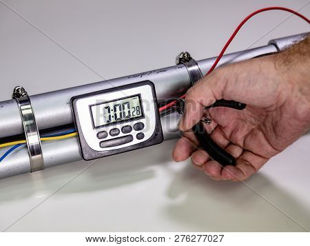 Hand Cutting Wire On Pipe Bomb On White Background
