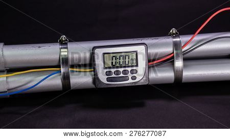 Pipe Bomb With An Clock Timer To Trigger Detonation On Black Background