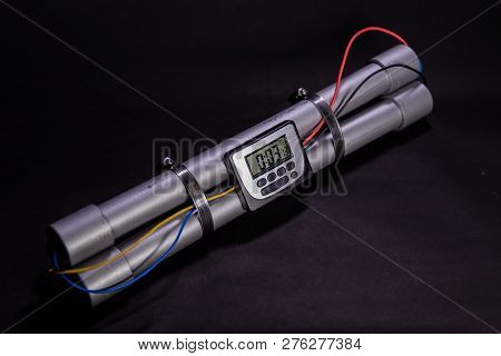Pipe Bomb With An Clock Timer To Trigger Detonation On Black Background