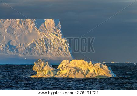 Antarctic Sunset: Floating Icebergs In The Weddell Sea, Near The Antarctic Peninsula, As Seen From A