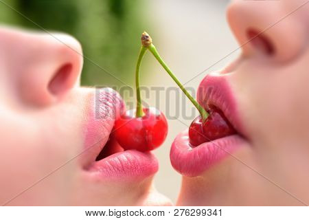 Lesbian Couple Kiss Lips. Sexy Lesbian Lovers Foreplay. Cherry And Temptation. Two Fruits For Two Wo
