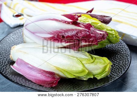 Group Of Fresh Green Belgian Endive Or Chicory And Red Radicchio Vegetables, Also Known As Witlof Sa