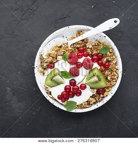 Breakfast Super Bowl Homemade Baked Granola With Yoghurt, Kiwi Slices, Currant, Mint, Basil And Fres