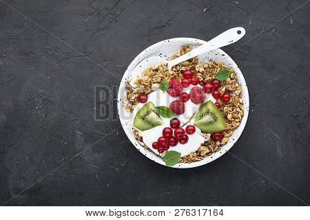 Breakfast Super Bowl Homemade Baked Granola With Yoghurt, Kiwi Slices, Currant, Mint, Basil And Fres