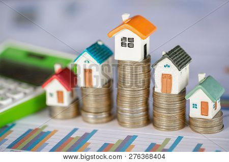 Mini House On Stack Of Coins,money And House,  Mortgage, Savings Money For Buy House And Loan To Bus