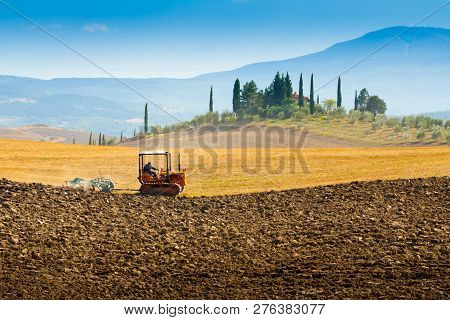 Ploughing On Hills In Southern Tuscany Near Siena, Italy