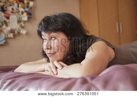 Nice Middle-aged Woman In The Bed Room. Lady At Home