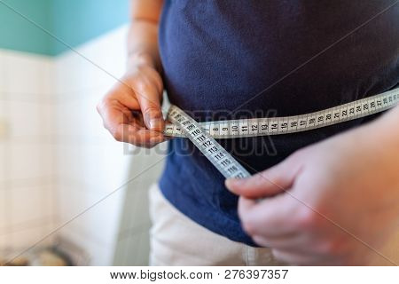 Man Measures Her Abdomen With A Measuring Tape