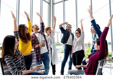 Young Multiethnic Diverse Creative Asian Group Huddle And High Five Hands Together In Office Worksho