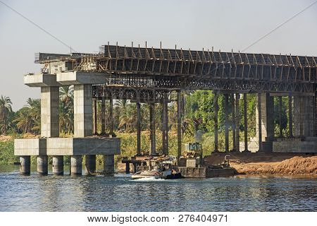 View Of Large Concrete Road Bridge Under Construction Spanning Wide Nile River In Egypt At Kom Ombo
