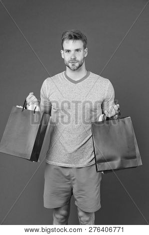Man Bearded Face Holds Shopping Bags. Guy Bought Lot Sporty Clothes And Accessories. Man Shopping On