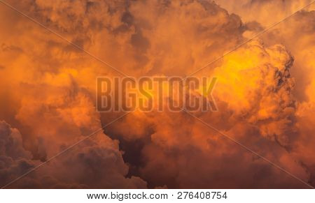 Dramatic Orange Sky And Clouds Abstract Background. Top View Of Orange Clouds. Warm Weather Backgrou