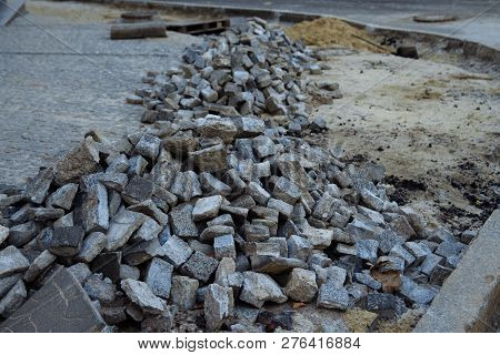 Heaps Of Paving Stones Lie On The Road, Laying Stones, Unfinished Work. Road Pedestrian Area