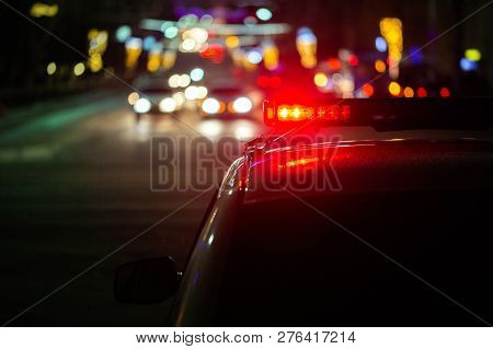 Police Car Lights At Night In City With Selective Focus And Bokeh
