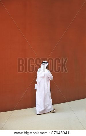 An Elegant Man Of Arab Ethnicity With Sunglasses Walks The Streets Of His Country