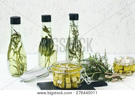 Marinated Feta In A Glass Jar, Spices And Flavored Olive Oil On A Wooden Background