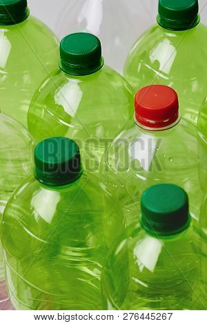Many Green Plastic Bottles With Caps. Production Of Beverages In Plastic Containers. Problem Of Envi