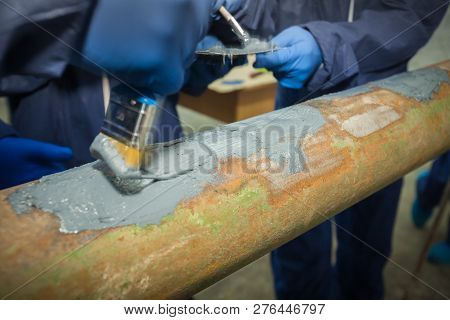 Restoration Of The Strength Characteristics Of The Industrial Pipeline. Resin Coating On Pipe. Hands