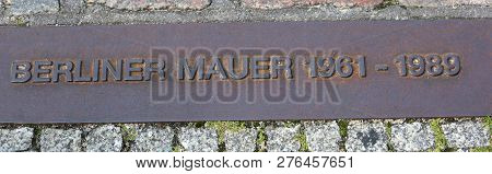 Commemorative Plaque Placed On The Site Where Once Stood The Berlin Wall With Big Text Berliner Wall