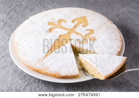 Tarta De Santiago. Traditional Almond Cake Slice From Santiago In Spain On Gray Background