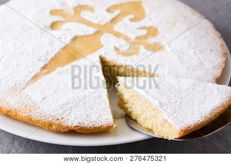 Tarta De Santiago. Traditional Almond Cake Slice From Santiago In Spain On Gray Background