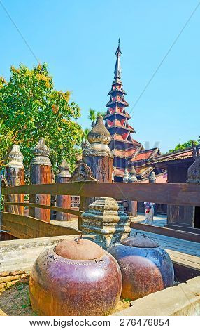 The Large Donation Bowls In Front Of The Fence Of The Medieval Wooden Bagaya Monastery, Ava (inwa), 