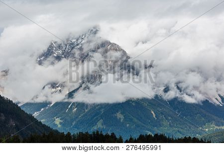 Summer Overcast Mountain Top In Clouds View From Fernpass, Austria, Near Zugspitze Mountain.