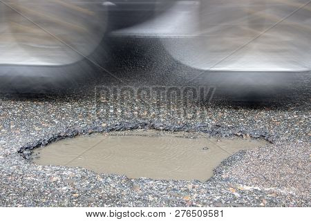 There Are Many Potholes On The Roadway Close Up