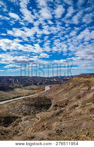 View From Summit Of Mcinnis Canyons In Utah With Blue Sky And Clouds.