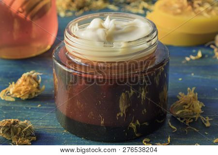 Facial Cream Of Calendula, Honey And Beeswax, On A Wooden Background