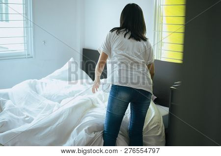 Make A Bed,woman Making Her Bed In Room After Wake Up