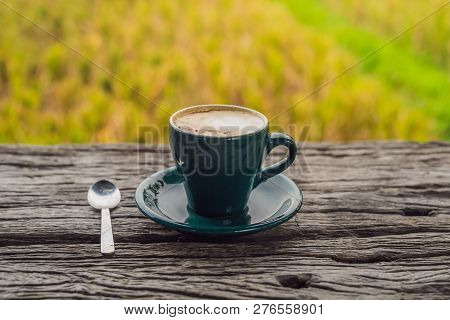 A Cup Of Coffee On The Background Of An Old Wooden Table