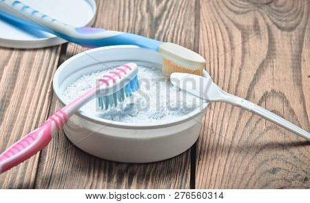 Toothpaste And Teethbrush On Wooden Table Close Yp