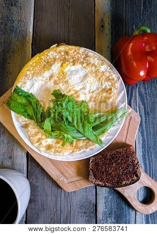 Fried Egg In The Form Of A Pancake, Wooden Cutting Board. Breakfast, Still Life.