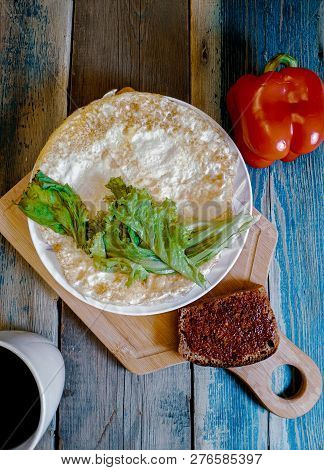 Fried Egg In The Form Of A Pancake, Wooden Cutting Board. Breakfast, Still Life.