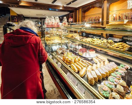 Strasbourg, France - Dec 29, 2018: Senior Woman Inside Traditional French Pastry Store, Riss Selling
