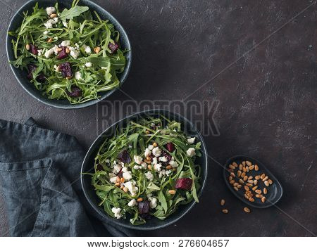 Beetroot, Aragula And Soft Cheese Salad Over Black Background. Top View Or Flat Lay. Copy Space For 