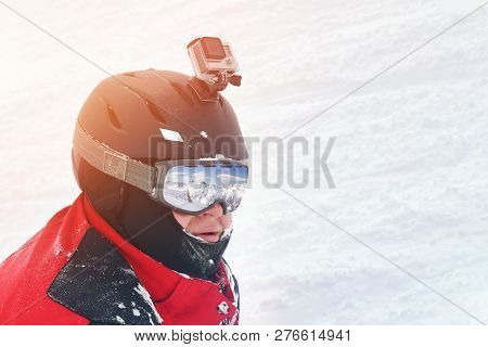 Snowboarder Or Skier Portrait In Sport Goggles And Protection Helmet With Mounted Action Camera And 