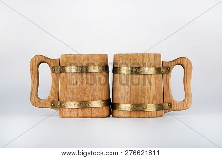 Two Oak Mugs For Beer Stand On A Gray Background