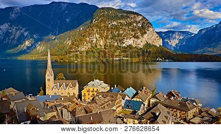 Panoramic Scenic View In Austrian Alps. Hallstatt Mountain Village At Hallstatt Lake. Sunny Day Lake