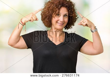 Beautiful middle ager senior woman over isolated background Smiling pointing to head with both hands finger, great idea or thought, good memory