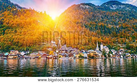 Panoramic Scenic Sunrise View Of Austrian Alps. Hallstatt Mountain Village At Hallstatt Lake. Sunny 