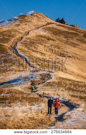 Wetlina, Poland, November 12, 2011: A Group Of Tourists Hiking On A Trail In Polonina Wetlinska On A